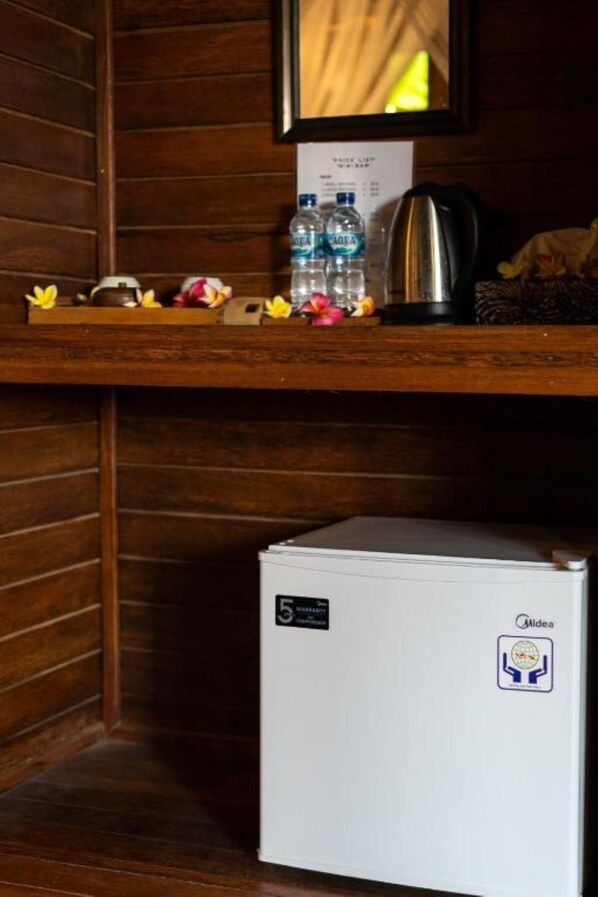 A small white refrigerator with a sticker indicating it is a 5-star hotel. - Karang Mas Villa Lembongan (Lembongan Island)