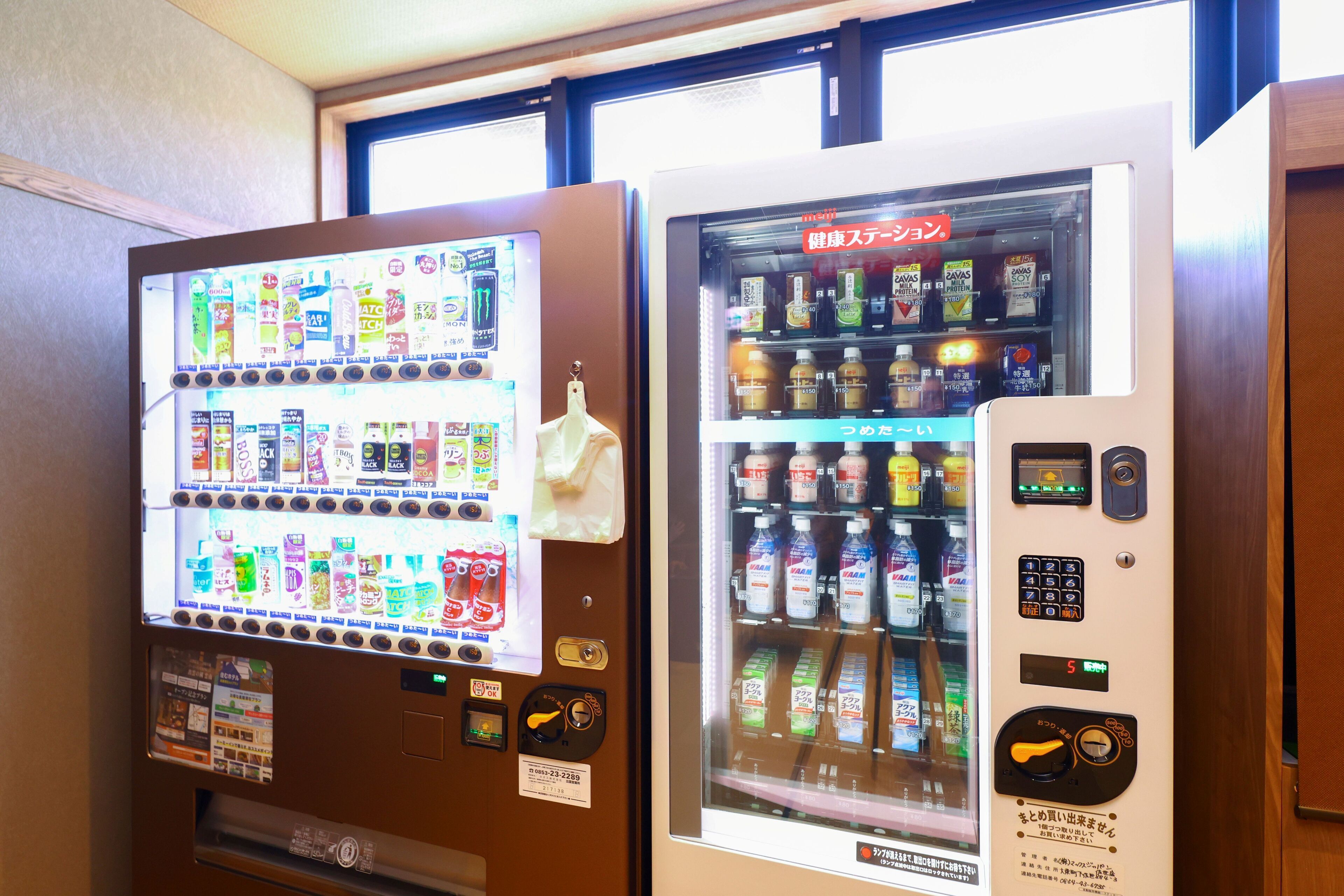 Two vending machines with various beverages and snacks.