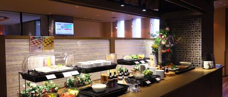 A buffet area with various food items and condiments.