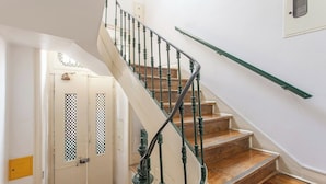 A staircase with green balusters and wooden steps leading to a landing. - 1 Bedroom Apartment Located in the Heart of Lisbon City (Lisbon)