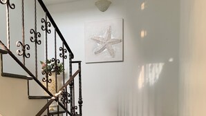 A staircase with a metal railing and a potted plant. - Don Michele Apartments (Gizzeria)