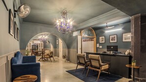 A modern interior with a bar area, seating, and a chandelier. - Victoria Mansion - A Signature Collection by HST Hotels (Udaipur)
