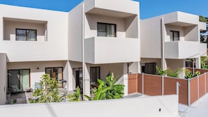 A modern two-story residential building with a flat roof, large windows, and a balcony. - Samos Tropic Apartments  (Samos)