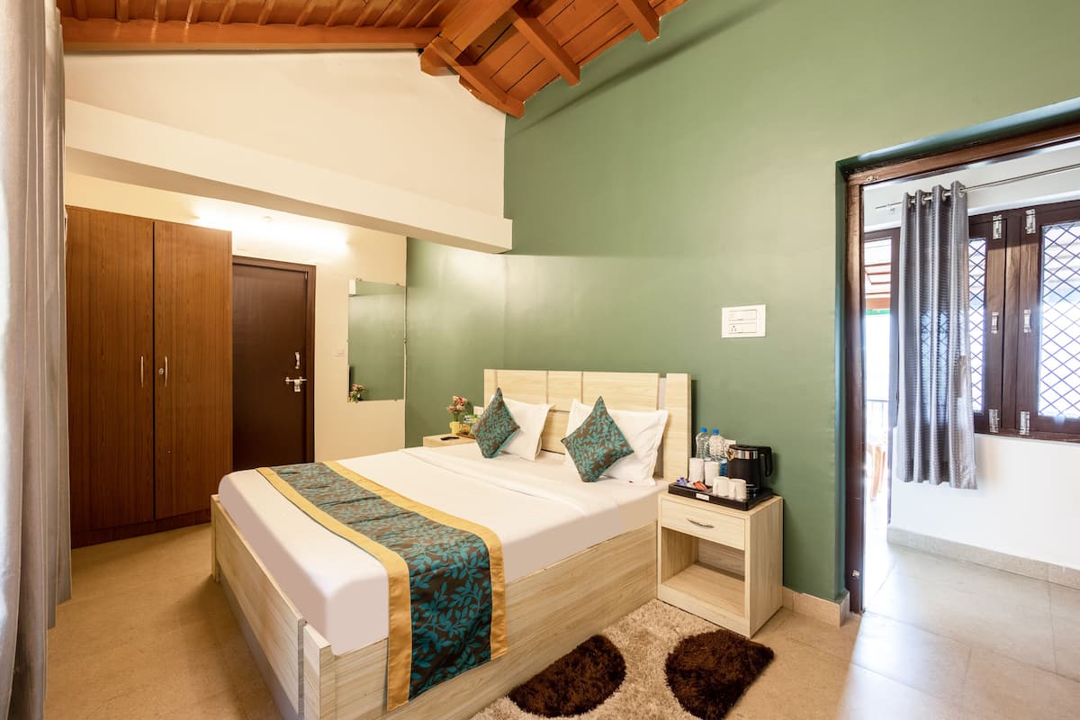 A bedroom with a bed, bedside table, and a wardrobe.