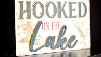 A sign with the text "HOOKED ON THE LAKE".