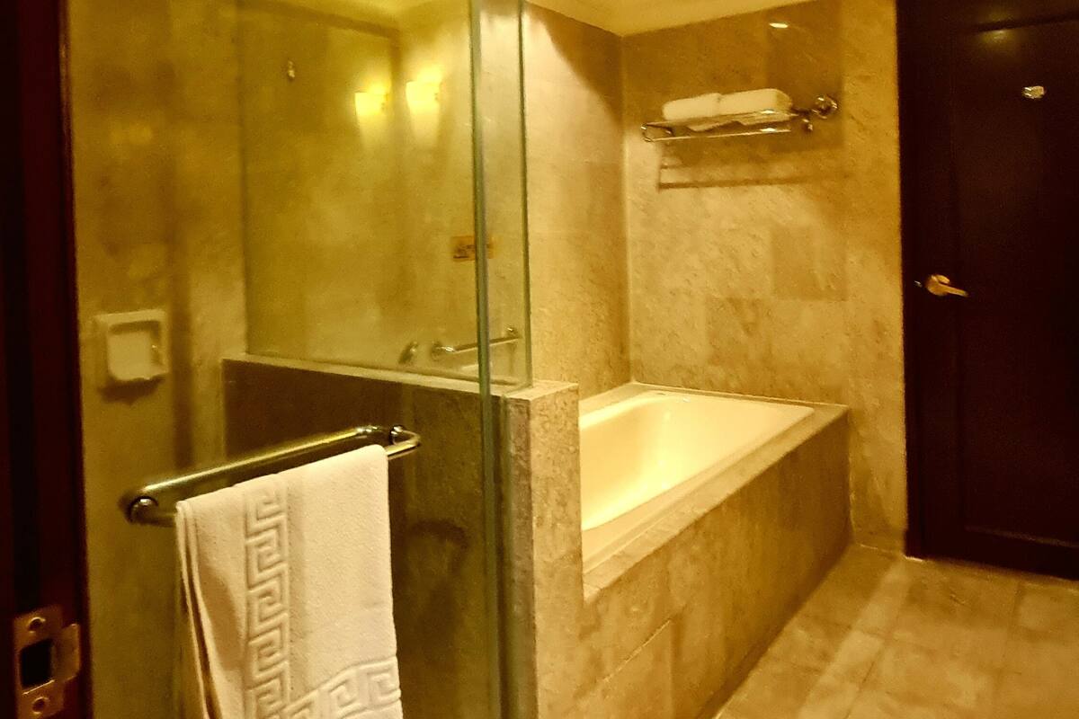 Separate bathtub and shower, hair dryer, towels, soap
