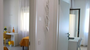 A modern hotel room with a dining area, a bathroom, and a living space. - OrangeSun Holiday Home x5 with parking (Massa Lubrense)