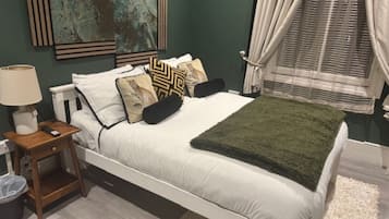 Deluxe Room, Garden View | In-room safe, desk, laptop workspace, blackout curtains