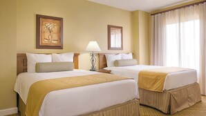 A hotel room with two beds, a nightstand, a lamp, and a window with curtains. - 2BR-Dlx Inside Disney Gates-5 Pools, 2 Lazy Rivers, SPLASH pad, Mini Golf & More (Lake Buena Vista)