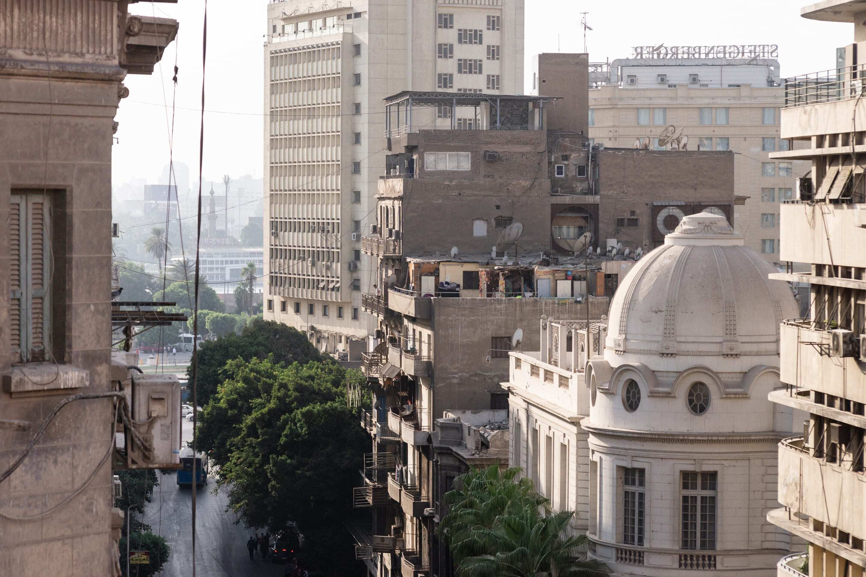 A cityscape with a mix of modern and historic buildings, including a prominent dome structure.