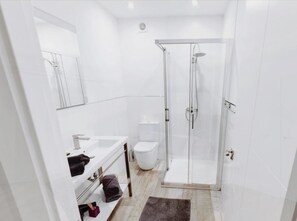 A modern bathroom with a glass-enclosed shower, a white sink, and a toilet. - Top Luxury Marbella Villa  (Marbella)