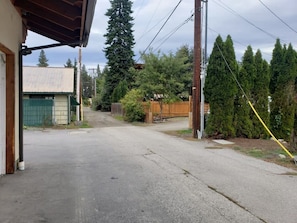 Stroll through a serene suburban neighborhood with a single-story building in the distance.
