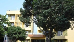 A multi-story building with a sign reading "AMIT GUEST HOUSE". - Hotel Amit Palace (Ambegaon)