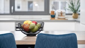A modern kitchen with a fruit bowl on the counter.