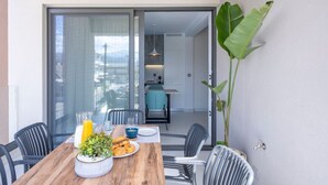 A dining area with a wooden table, chairs, and a potted plant.