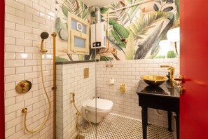 Bathroom features a distinctive design with subway tiles and a patterned floor.