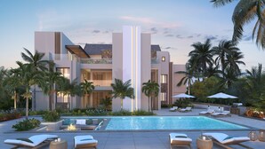 Un resort moderno con piscina, sillas de descanso y palmeras.