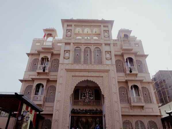A traditional building with intricate architectural details, including ornate balconies and a central archway. - Hotel Ratan Mahal (Datia)