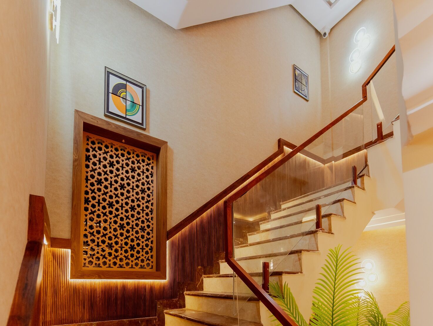 A staircase with wooden railings and a patterned wall panel.