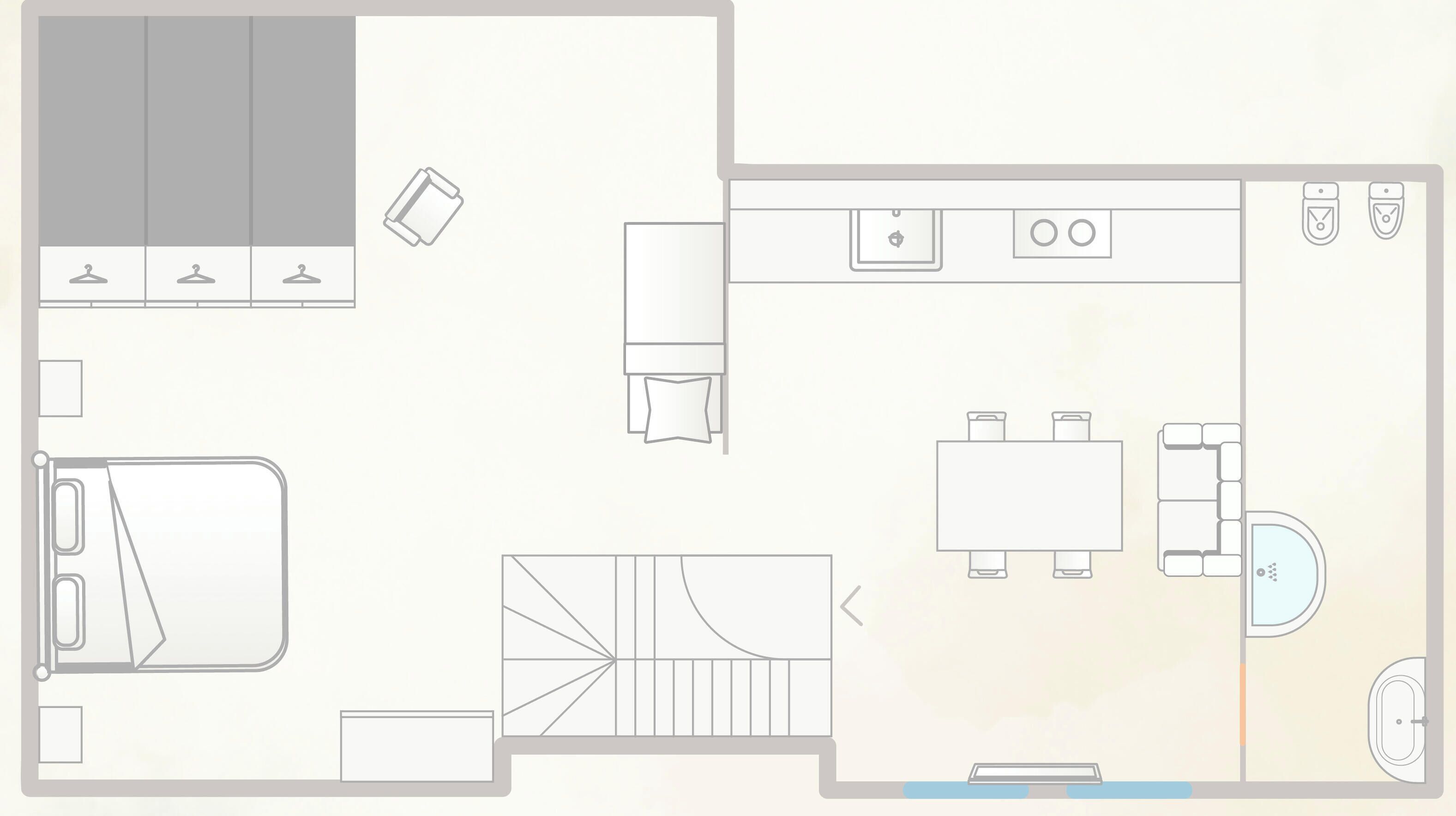 A floor plan of a hotel room with a bed, a desk, a chair, a wardrobe, a bathroom, and a small sitting area.