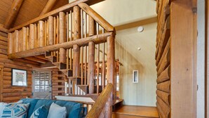 A wooden staircase with a wooden handrail and steps, leading to a second floor. - New to Lake Norman! Cozy Cabin with Big Water Views! (Sherrills Ford)