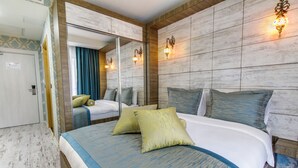 A hotel room with a large bed, a mirror, and wall-mounted lights. - Elite World Nest Sivas (Sivas)