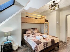 A loft-style bedroom with a bunk bed, a desk, a lamp, and a ladder. - Mt Green 3-d10 (Killington)
