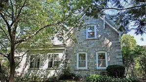 A stone house with a gabled roof and a small dormer window. - Beautiful 1 Bedroom, 1 Bathroom in Medford with WiFi and AC (Medford)