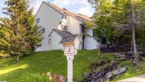 A residential house with a mailbox labeled 'WEST GLADE J 1-4 180'. - Sunrise - W Glade J-1 (Killington)
