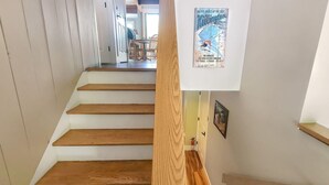 A staircase with wooden steps leading to a room. - Great Escape Ski Lodge (Killington)