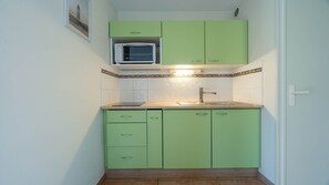 Fridge, microwave, coffee/tea maker, cookware/dishes/utensils