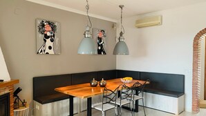 A modern kitchen with a wooden table, black and white chairs, and pendant lights. - Mountain villa + sea view. Privacy, tranquillity. Near Javéa, Moraira and Dénia (VC)
