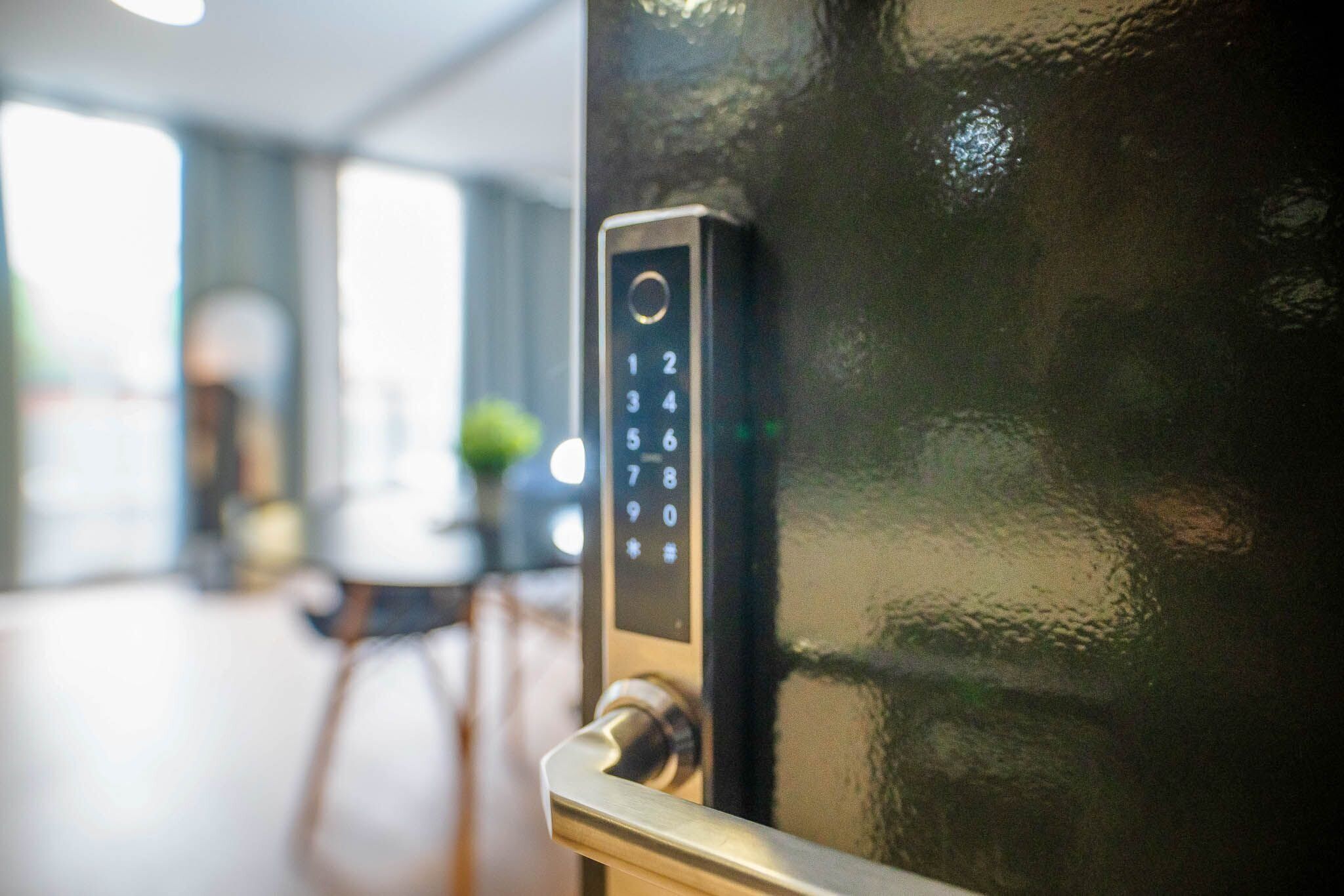 A close-up of a modern door lock with a keypad.