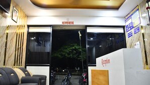 A reception area with a sign reading "Reception" and a sign above the entrance that says "Dhanvad". - Hotel Kalika Residency - Akkalkot (Akalkot)