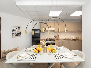 Enjoy meals in this kitchen with an oven, refrigerator, and dining area for two.