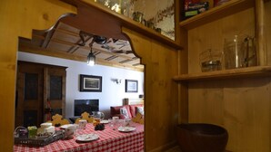 A dining area with a red and white checkered tablecloth, wooden furniture, and a rustic interior.