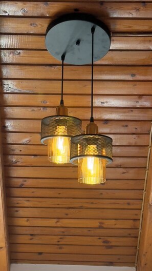 A ceiling with wooden paneling and two hanging pendant lights with a mesh design. - Olga's Sea View Studios -500m from Ipsos (Corfu)