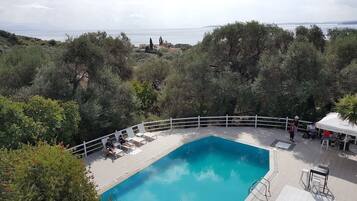 Seasonal outdoor pool, open 8:00 AM to 8:00 PM, pool loungers