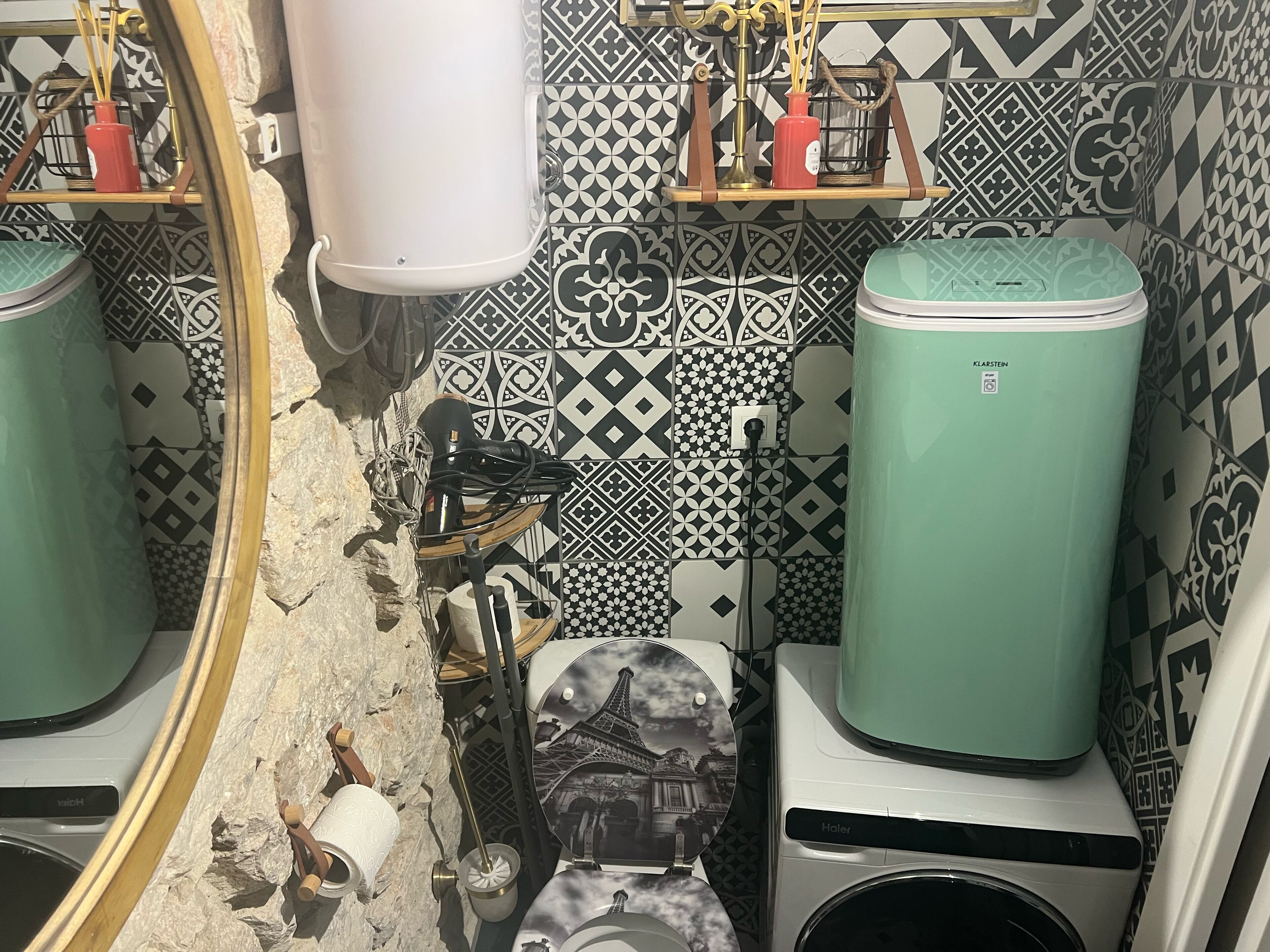 A bathroom with two water heaters, a toilet, and a sink.
