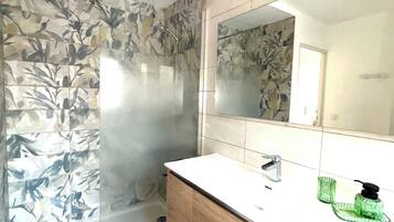 Shower, hair dryer, towels, toilet paper