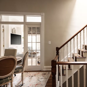 A staircase with white balusters and a wooden handrail leading to a landing. - Charming 4-Bedroom Home in Historic Old Town - minutes from King St, DC, & Metro (Alexandria)