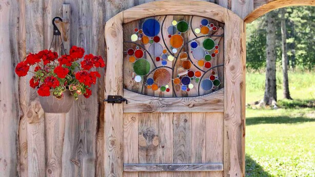 A wooden door with a stained glass window and a hanging flower basket. - Private Blue Pine Getaway (Duluth)