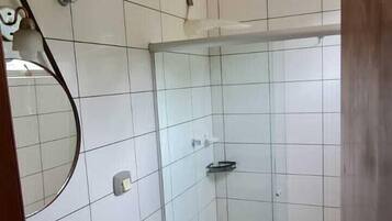 A bathroom with a shower, toilet, and sink.