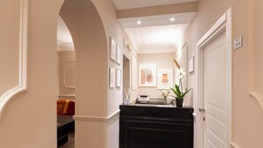 A hallway with a black reception desk, framed artwork on the walls, and a door labeled "ROOM 304". - HOTEL MAGIC (Rome)