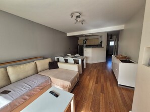 A compact living space with a sofa, a small table, a kitchenette, and a dining area. - 3-room 2-bedroom apartment close to the ramparts of Vannes (Vannes)