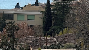 A coastal view with buildings and trees.