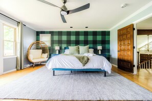 A bedroom with a bed, a ceiling fan, a window with curtains, a wicker chair, and a wooden door. - 4mi to Buffalo Trace, Hot Tubs, Gameroom, Firepit (Frankfort)