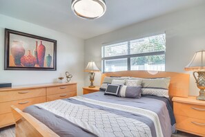 A bedroom with a bed, bedside tables, a window, and a painting on the wall. - 2 Mi to Beach: Home w/ Pool, Grill & More in Largo (Largo)