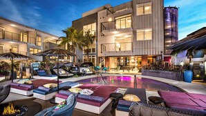 A modern hotel with a pool area, outdoor seating, and a well-lit entrance. - Oasis 2BD/2BA near Beverly Grove w/ Parking, Gym and in unit Washer/Dryer (Los Angeles)