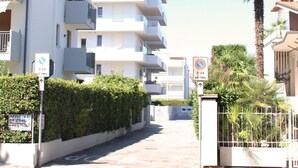 A multi-story building named "Casa Miriam" with a modern architectural style, featuring balconies and a gated entrance. - Dainese Apartments, Casa Miriam (Jesolo)